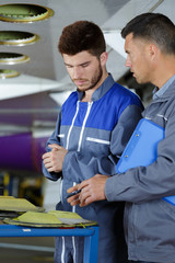 workers installing sound system in car