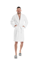 Handsome man wearing bathrobe on white background