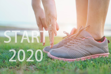 2020 the start into the new year.sports background. legs of runner feet running on road