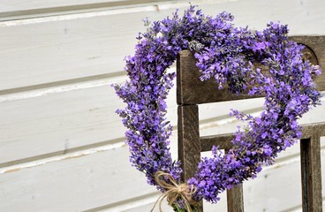 Lavender wreath in the shape of a heart on a chair close-up
