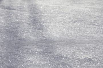 The texture of the snow. Winter rainfall. Tracks on a snowy road after a snowfall.