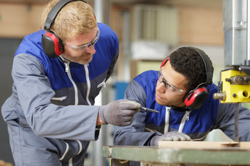 young manual worker wearing protective clothing in metal industry
