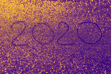 Flickering banner with inscription 2020 on a golden violet shiny background.