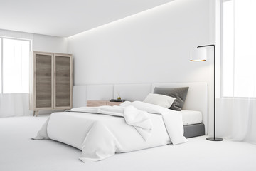 White bedroom corner with single bed and wardrobe