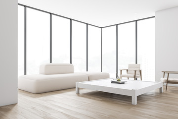 White living room corner with sofa and table