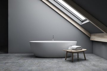 Attic gray bathroom interior with tub and bench