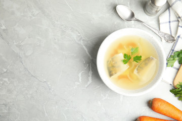 Delicious fish soup served on marble table, flat lay. Space for text