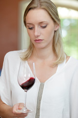 young woman observing wine characteristic