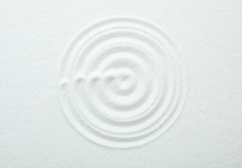Top view of white sand with pattern. Zen and harmony
