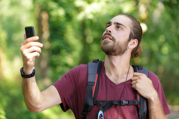 hiker searching a mobile phone signal