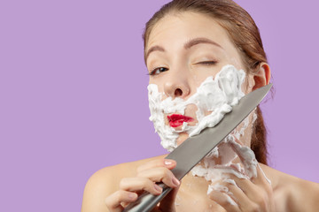 woman shaves her face