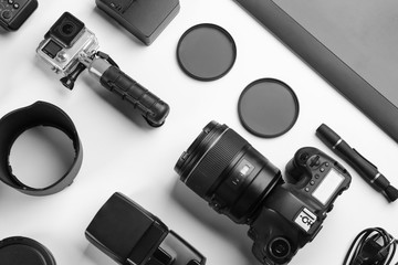 Composition with photographer's equipment and accessories on white background, top view