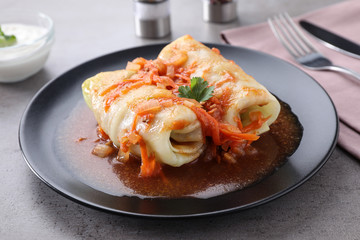 Delicious cabbage rolls served on grey table, closeup