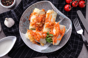 Delicious cabbage rolls served on grey table, flat lay