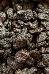 A full frame photograph of prunes for sale on a market stall