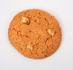 Oatmeal cookies with crushed walnut on a gray texture background