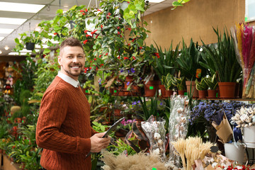 Male business owner with clipboard in his flower shop
