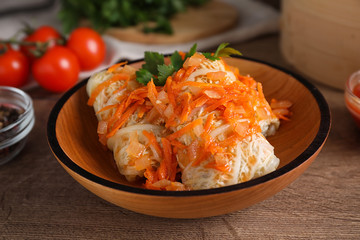 Delicious cabbage rolls on wooden table, closeup
