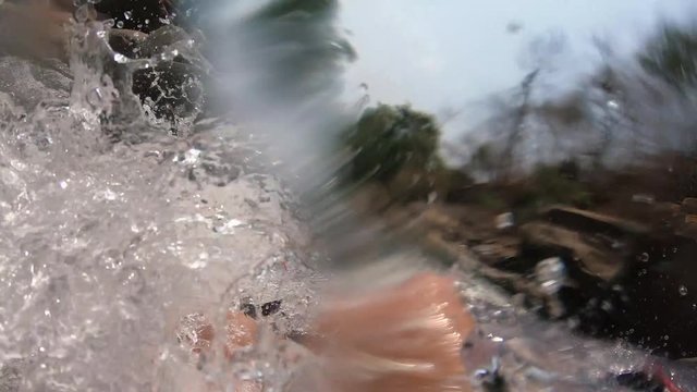 POV of Male in a Canoe on a Small River with Rapic Water Almost Collapsing