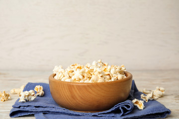 Tasty pop corn on white wooden table