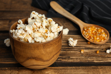 Tasty fresh pop corn on wooden table, closeup