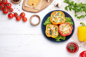 Flat lay composition with tasty stuffed bell peppers on white wooden table, space for text