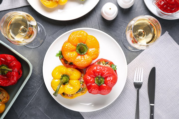 Tasty stuffed bell peppers served on grey table, flat lay