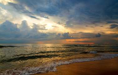 Obraz premium silhouettes of people walking on seashore at sunset