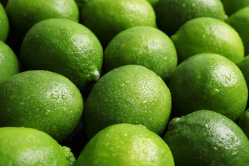 Fresh ripe juicy limes as background, closeup