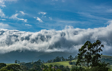 Cloud covering the mountain. Mountain peak  covered by clouds and fog. Dramatic scene. 