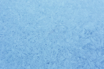 Fototapeta na wymiar Beautiful winter texture of hoar frost on window frozen glass.