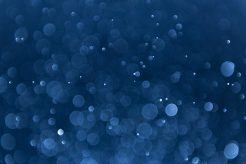 abstract sparkle bokeh light effect with navy blue background