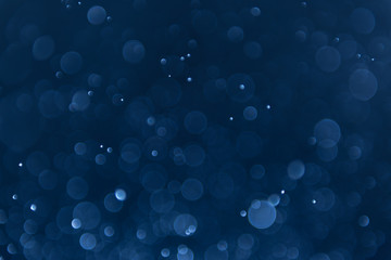 abstract sparkle bokeh light effect with navy blue background - obrazy, fototapety, plakaty