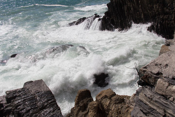 Marine landscape. Waves are crashing on rocks.