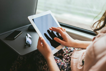 Woman using a digital tablet on the train - 306659890
