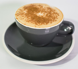 Cup of fresh cappuccino on a white background. The drinks.