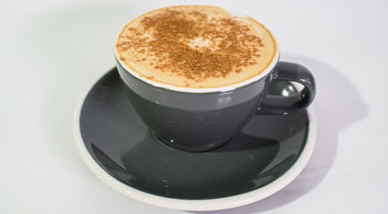 Cup of fresh cappuccino on a white background. The drinks.