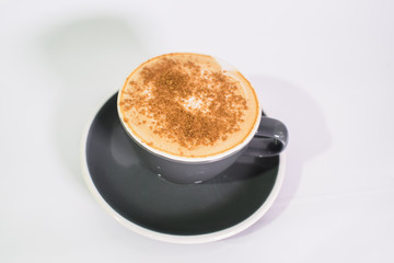 Cup of fresh cappuccino on a white background. The drinks.