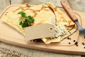 pancakes with ham and cheese on a cutting board