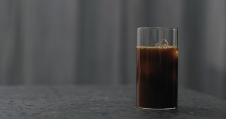 iced coffee in glass on terrazzo countertop