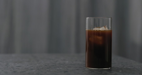 iced coffee in glass on terrazzo countertop