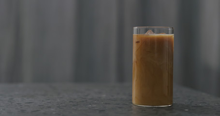 iced coffee with milk on terrazzo countertop