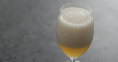 pour unfiltered wheat beer into tulip glass with copy space