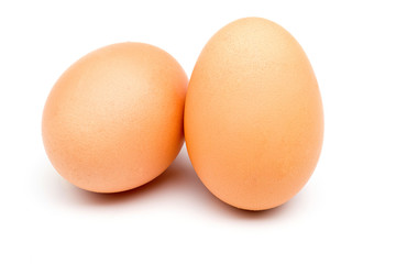 Two chicken eggs on a white background.