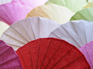 Colorful umbrellas paper art abstract background.