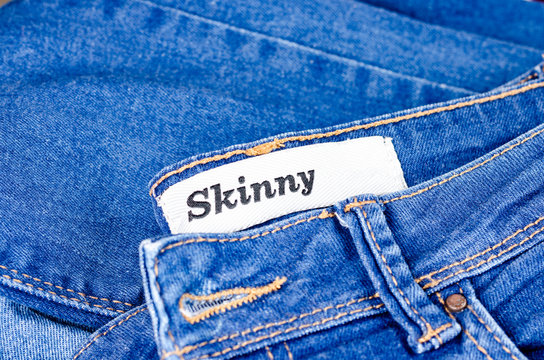 Modern young blue jeans denim with tag skinny for lean people . Women and Men fashion accessory .Top view, copyspace.