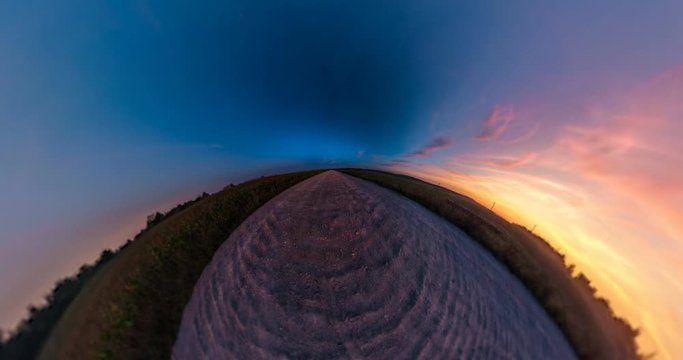 Little planet Transformation with curvature of space. Abstract torsion and spinning of full flyby panorama among fields in sunny evening with awesome clouds.  