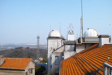 Shanghai sheshan astronomical observatory, antennas and planetarium roof with mountain background.
