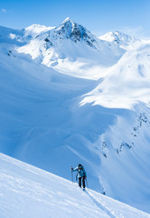 Naklejka na ściany i meble women backcountry skiing in the mountains