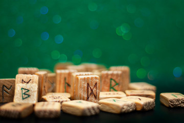 Group of old wooden runes on a green bokeh background
